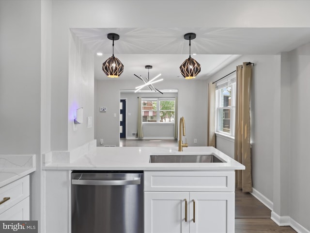 610 Galveston Pl SE, Washington, DC 20032 - kitchen with stainless steel dishwasher, a sink, white cabinetry, a chandelier, and hanging light fixtures