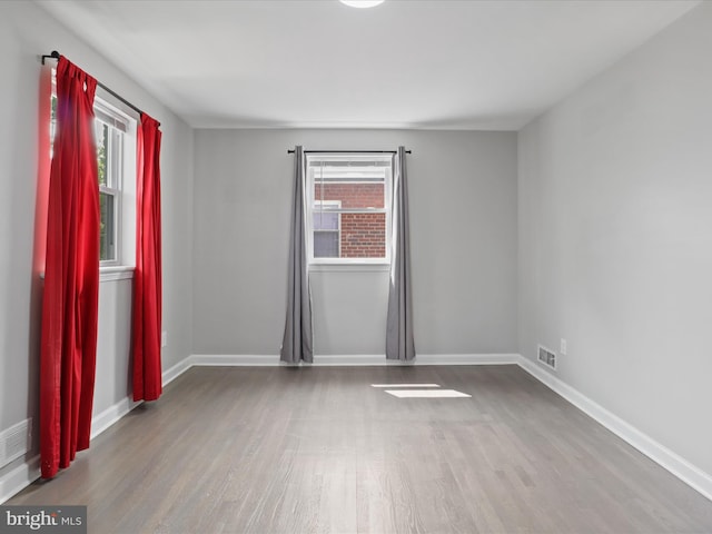 610 Galveston Pl SE, Washington, DC 20032 - unfurnished room featuring plenty of natural light, wood finished floors, and baseboards
