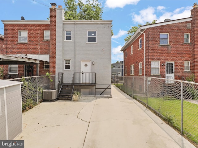 610 Galveston Pl SE, Washington, DC 20032 - back of property featuring brick siding, a chimney, and central air condition unit