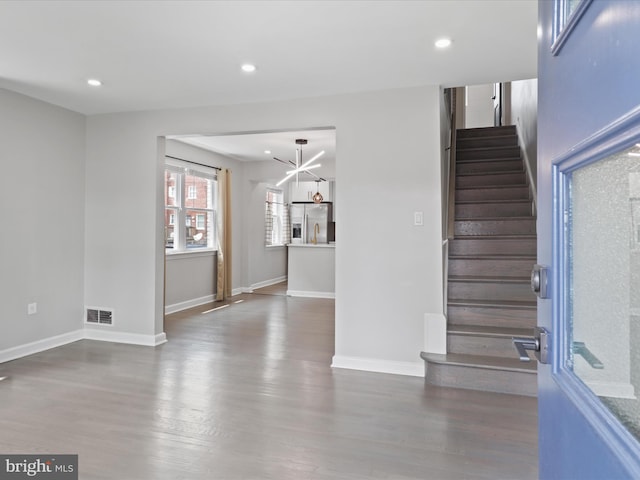610 Galveston Pl SE, Washington, DC 20032 - stairs with wood finished floors, recessed lighting, baseboards, and a chandelier