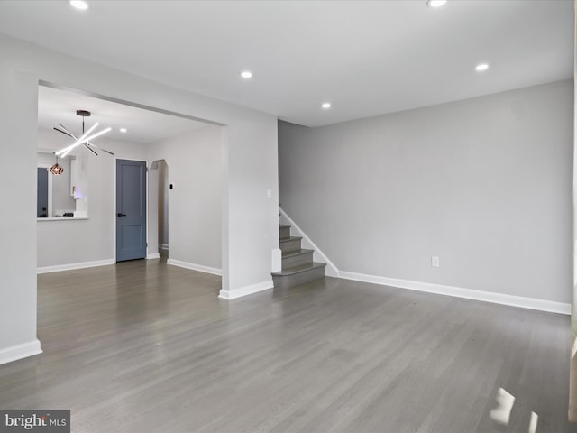 610 Galveston Pl SE, Washington, DC 20032 - unfurnished living room with recessed lighting, baseboards, wood finished floors, stairway, and a chandelier