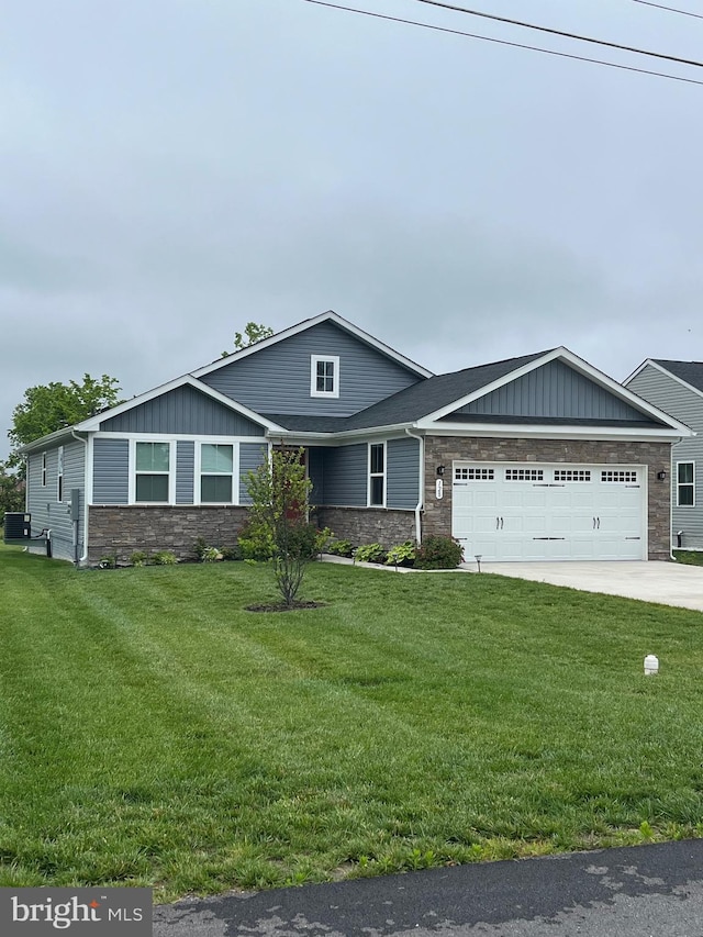 128 Massie Ln, Stephens City, VA 22655 - view of front of property with stone siding, board and batten siding, a garage, and a front lawn