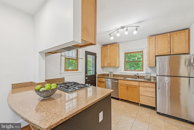 2937 Fort Baker Dr SE, Washington, DC 20020 - kitchen featuring stainless steel appliances, a sink, light tile patterned floors, a peninsula, and light stone counters