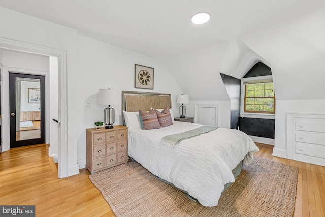 2937 Fort Baker Dr SE, Washington, DC 20020 - bedroom featuring light wood finished floors, vaulted ceiling, and baseboards