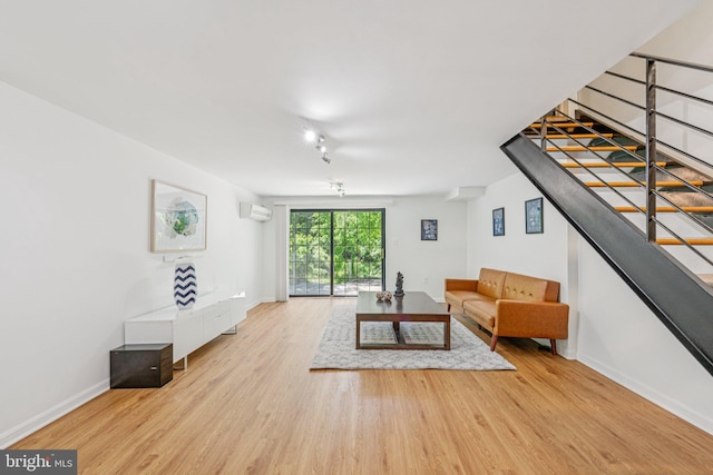 2937 Fort Baker Dr SE, Washington, DC 20020 - unfurnished living room featuring a wall unit AC, wood finished floors, baseboards, and stairway