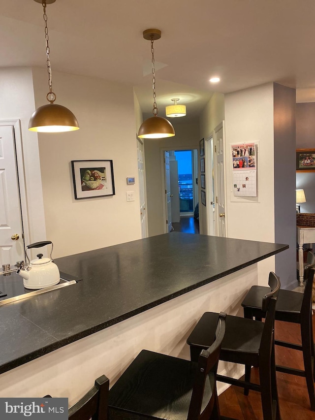 100 Harborview Unit 2307, Baltimore, MD 21230 - kitchen with a kitchen breakfast bar, pendant lighting, dark countertops, and a peninsula
