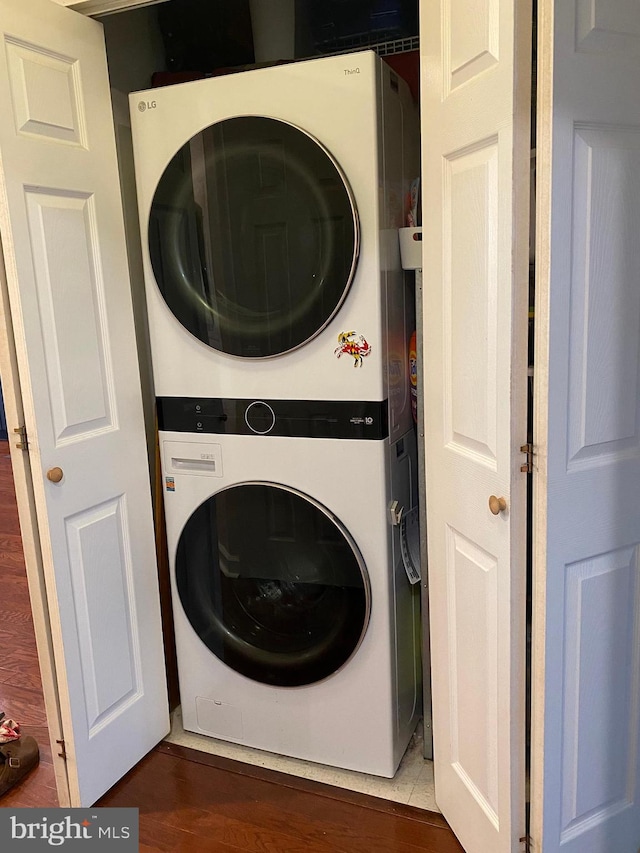 100 Harborview Unit 2307, Baltimore, MD 21230 - washroom with stacked washer / dryer and wood finished floors