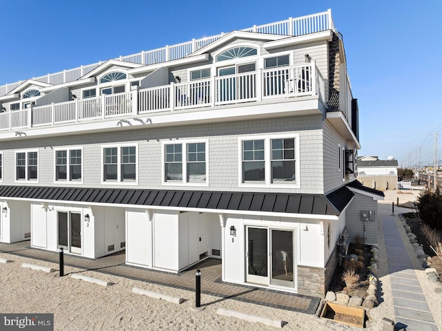 2600 Long Beach Blvd Unit 6, Long Beach Township, NJ 08008 - back of property with a standing seam roof, a balcony, board and batten siding, and metal roof