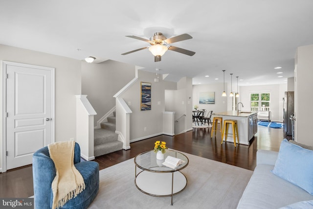 9950 Ravenhurst Rd, Middle River, MD 21220 - living room with dark wood finished floors, ceiling fan, stairway, and recessed lighting