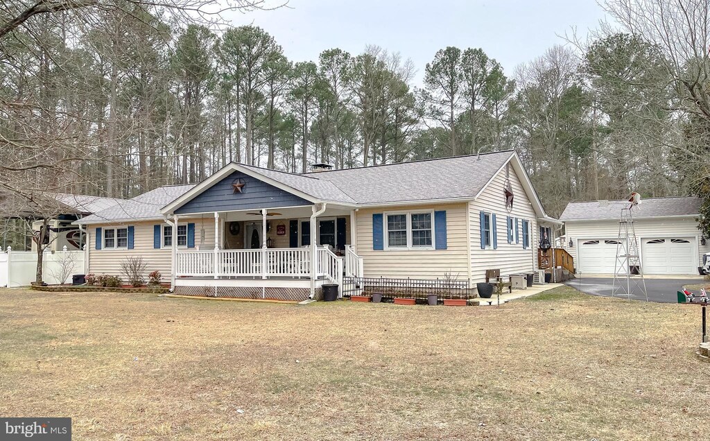 43985 Main Way Rd, Leonardtown, MD 20650 - ranch-style house featuring a porch, an outbuilding, a shingled roof, and view of wooded area
