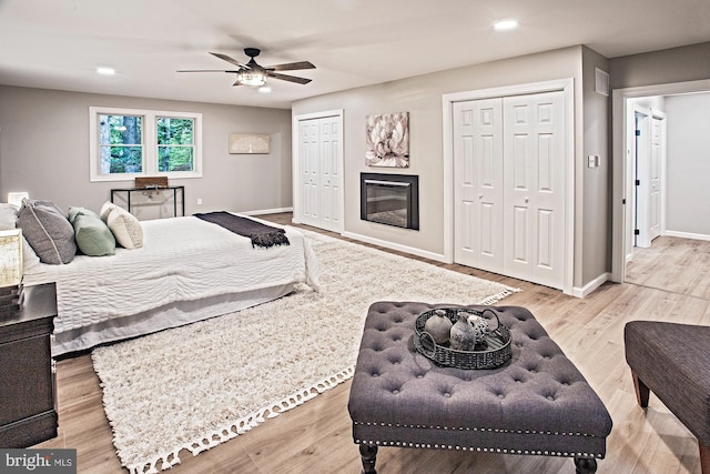118 Bock Ave, Wenonah, NJ 08090 - bedroom featuring two closets, recessed lighting, baseboards, wood finished floors, and a glass covered fireplace