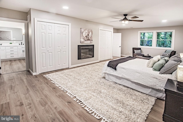 118 Bock Ave, Wenonah, NJ 08090 - bedroom featuring two closets, light wood finished floors, recessed lighting, ensuite bathroom, and baseboards