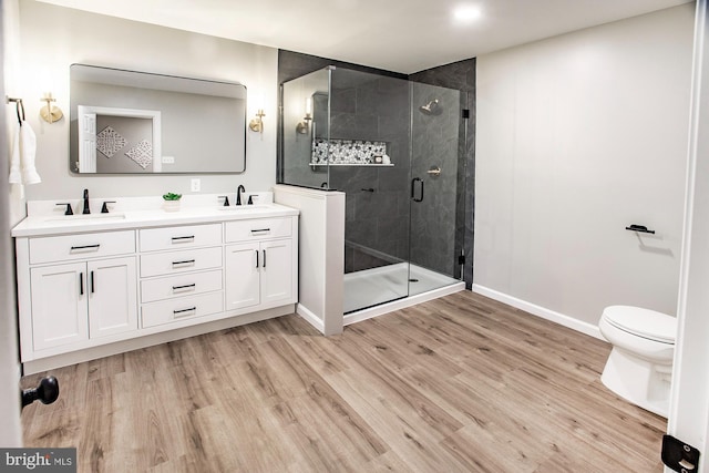 118 Bock Ave, Wenonah, NJ 08090 - bathroom featuring baseboards, double vanity, wood finished floors, a shower stall, and toilet