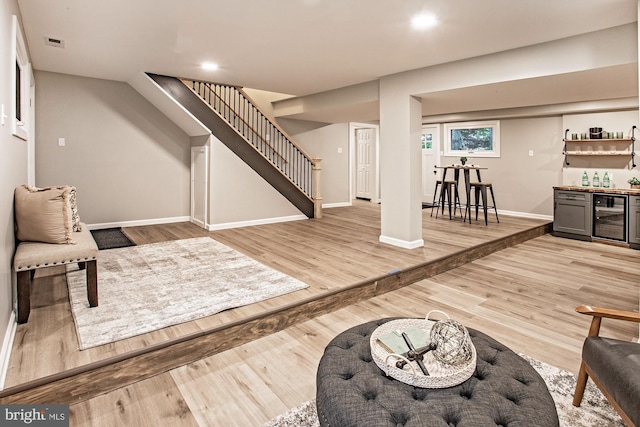 118 Bock Ave, Wenonah, NJ 08090 - living room with wine cooler, bar with sink, stairway, baseboards, and light wood-type flooring