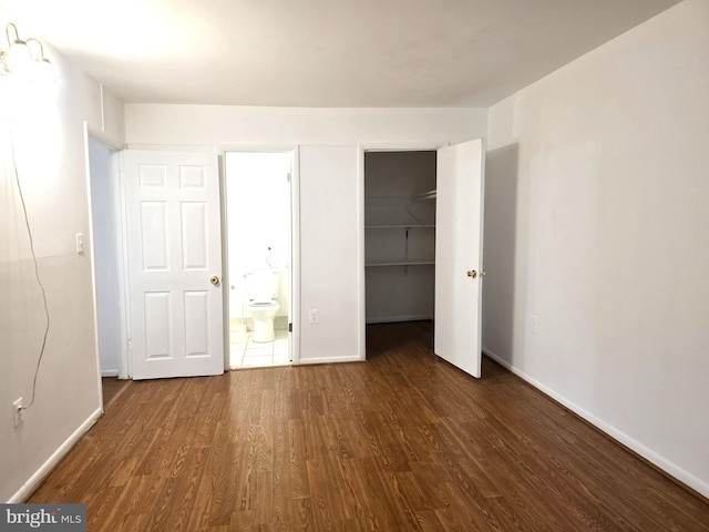 3376 Woodburn Rd, Annandale, VA 22003 - unfurnished bedroom with wood finished floors, a walk in closet, a closet, and ensuite bath