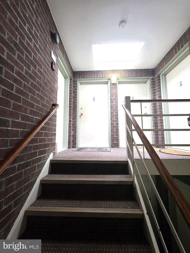 3376 Woodburn Rd, Annandale, VA 22003 - stairs with brick wall and a skylight