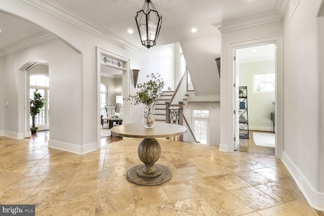 5420 Moorland Ln, Bethesda, MD 20814 - entryway featuring healthy amount of natural light, crown molding, stone tile floors, baseboards, and arched walkways