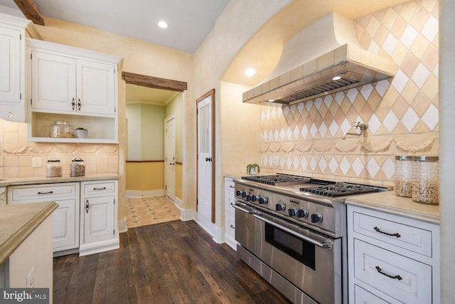 5420 Moorland Ln, Bethesda, MD 20814 - kitchen with high end stainless steel range oven, wall chimney exhaust hood, light countertops, baseboards, and decorative backsplash