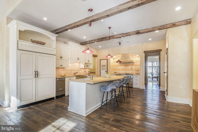 5420 Moorland Ln, Bethesda, MD 20814 - kitchen featuring dark wood-type flooring, beam ceiling, backsplash, a center island with sink, and recessed lighting