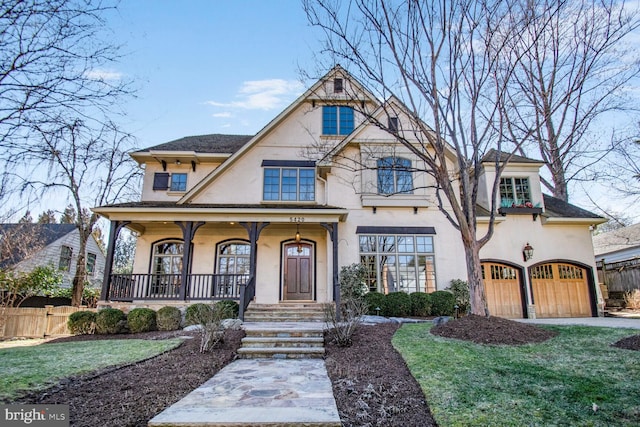 5420 Moorland Ln, Bethesda, MD 20814 - view of front of property featuring stucco siding, a garage, and covered porch