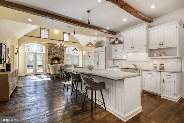5420 Moorland Ln, Bethesda, MD 20814 - kitchen featuring beam ceiling, a sink, white cabinets, a center island, and open shelves