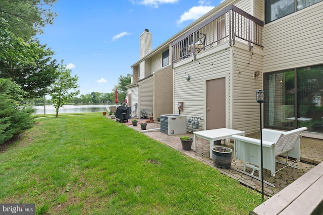 13 Tulip Ct, Mount Laurel, NJ 08054 - view of grassy yard featuring a water view, a patio, a balcony, and cooling unit