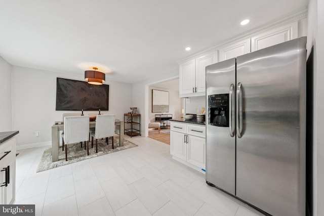 12711 Lampton Ln, Fort Washington, MD 20744 - kitchen with stainless steel fridge with ice dispenser, dark countertops, white cabinets, recessed lighting, and baseboards