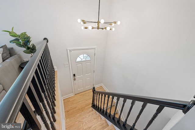 12711 Lampton Ln, Fort Washington, MD 20744 - entrance foyer with a chandelier, light wood finished floors, baseboards, and a high ceiling