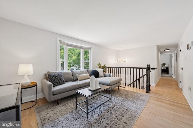 12711 Lampton Ln, Fort Washington, MD 20744 - living area with a chandelier, light wood-type flooring, and baseboards