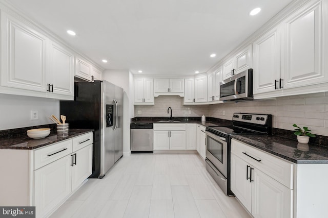 12711 Lampton Ln, Fort Washington, MD 20744 - kitchen featuring appliances with stainless steel finishes, a sink, white cabinetry, tasteful backsplash, and recessed lighting