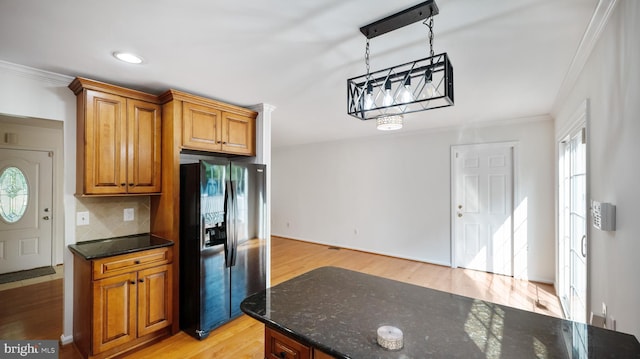 13413 Winterspoon Ln, Germantown, MD 20874 - kitchen with black refrigerator with ice dispenser, crown molding, light wood finished floors, dark stone countertops, and recessed lighting