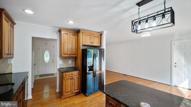 13413 Winterspoon Ln, Germantown, MD 20874 - kitchen featuring refrigerator with ice dispenser, backsplash, light wood-type flooring, crown molding, and decorative light fixtures