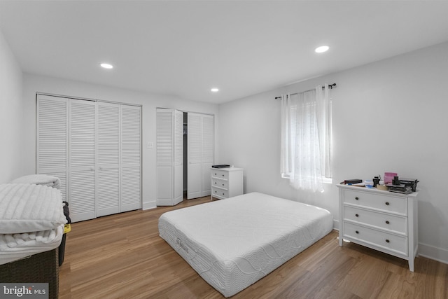 13413 Winterspoon Ln, Germantown, MD 20874 - bedroom with multiple closets, light wood-type flooring, and recessed lighting