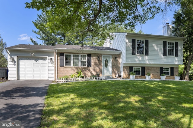 13413 Winterspoon Ln, Germantown, MD 20874 - tri-level home featuring brick siding, driveway, a garage, a chimney, and a front yard