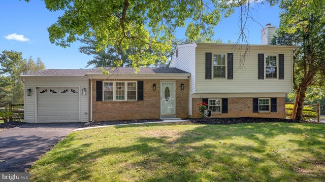 13413 Winterspoon Ln, Germantown, MD 20874 - split level home with a garage, brick siding, asphalt driveway, a chimney, and a front yard