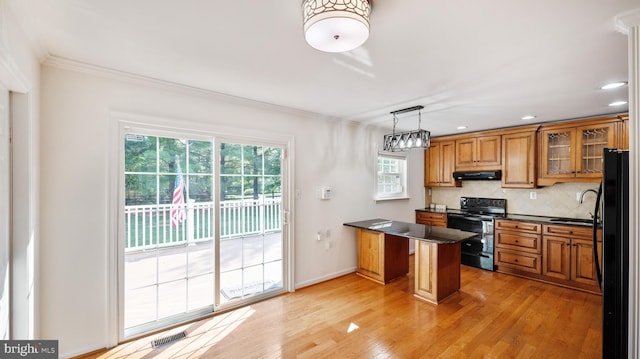 13413 Winterspoon Ln, Germantown, MD 20874 - kitchen with black appliances, exhaust hood, brown cabinets, ornamental molding, and a peninsula