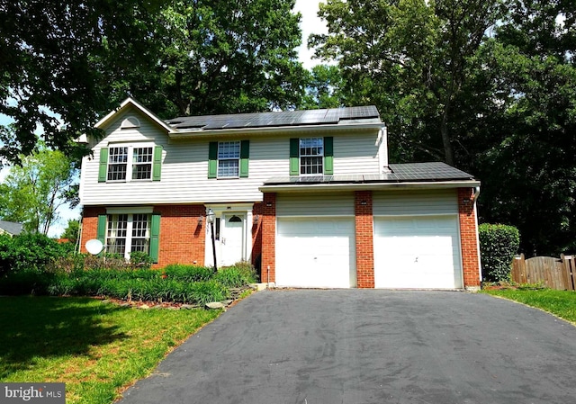8307 Satinleaf Ct, Bowie, MD 20715 - view of front facade featuring asphalt driveway, brick siding, and solar panels