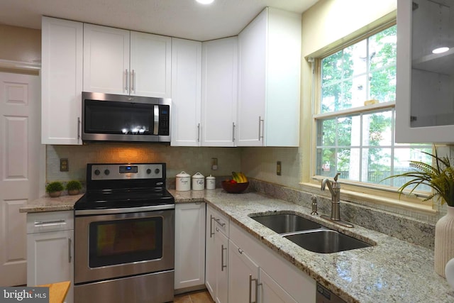 8307 Satinleaf Ct, Bowie, MD 20715 - kitchen with appliances with stainless steel finishes, white cabinetry, and decorative backsplash