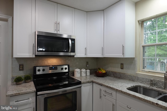 8307 Satinleaf Ct, Bowie, MD 20715 - kitchen with stainless steel appliances, white cabinetry, and tasteful backsplash