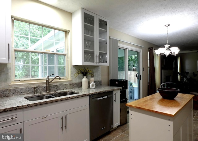 8307 Satinleaf Ct, Bowie, MD 20715 - kitchen with dishwasher, butcher block countertops, backsplash, glass insert cabinets, and plenty of natural light