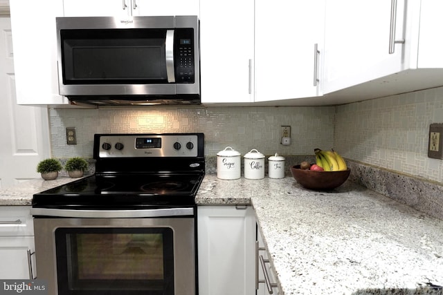 8307 Satinleaf Ct, Bowie, MD 20715 - kitchen with appliances with stainless steel finishes, white cabinetry, backsplash, and light stone counters
