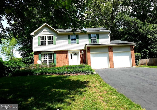 8307 Satinleaf Ct, Bowie, MD 20715 - view of front of house featuring asphalt driveway, brick siding, a garage, and roof mounted solar panels