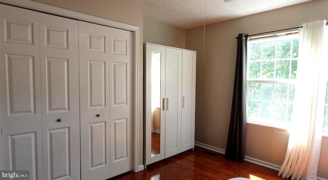 8307 Satinleaf Ct, Bowie, MD 20715 - unfurnished bedroom featuring dark wood-type flooring and baseboards