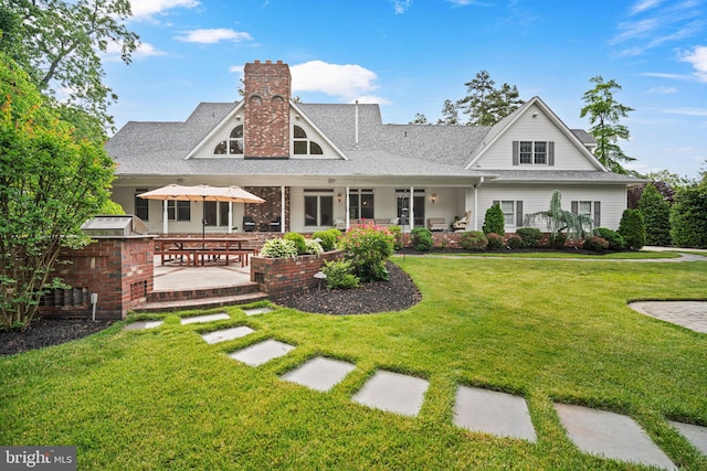 14 Waterfront Way, Hammonton, NJ 08037 - back of property featuring a patio area, a lawn, a chimney, and a shingled roof