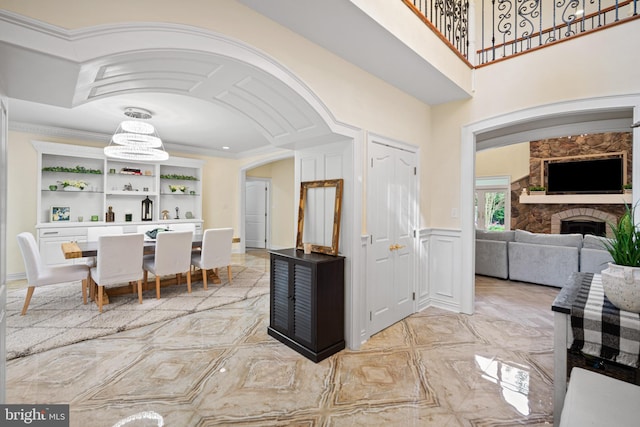 14 Waterfront Way, Hammonton, NJ 08037 - kitchen featuring open shelves, a chandelier, a stone fireplace, arched walkways, and crown molding