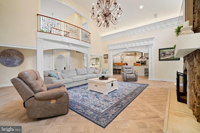 14 Waterfront Way, Hammonton, NJ 08037 - living room with arched walkways, a chandelier, baseboards, and a high ceiling