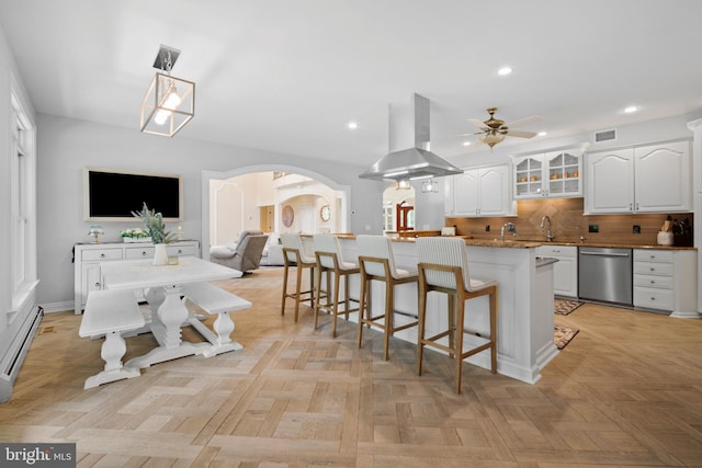 14 Waterfront Way, Hammonton, NJ 08037 - kitchen with dishwasher, island exhaust hood, a ceiling fan, white cabinets, and arched walkways