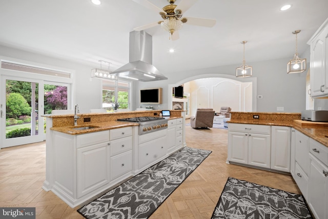 14 Waterfront Way, Hammonton, NJ 08037 - kitchen with a sink, stainless steel gas stovetop, island exhaust hood, arched walkways, and white cabinetry