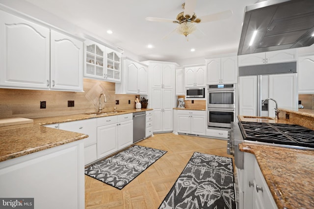 14 Waterfront Way, Hammonton, NJ 08037 - kitchen featuring a sink, built in appliances, wall chimney exhaust hood, ceiling fan, and light stone counters
