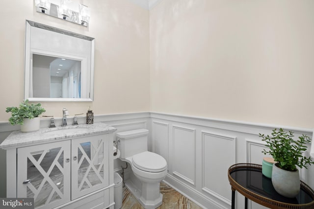14 Waterfront Way, Hammonton, NJ 08037 - bathroom featuring toilet, wainscoting, vanity, wood finished floors, and a decorative wall
